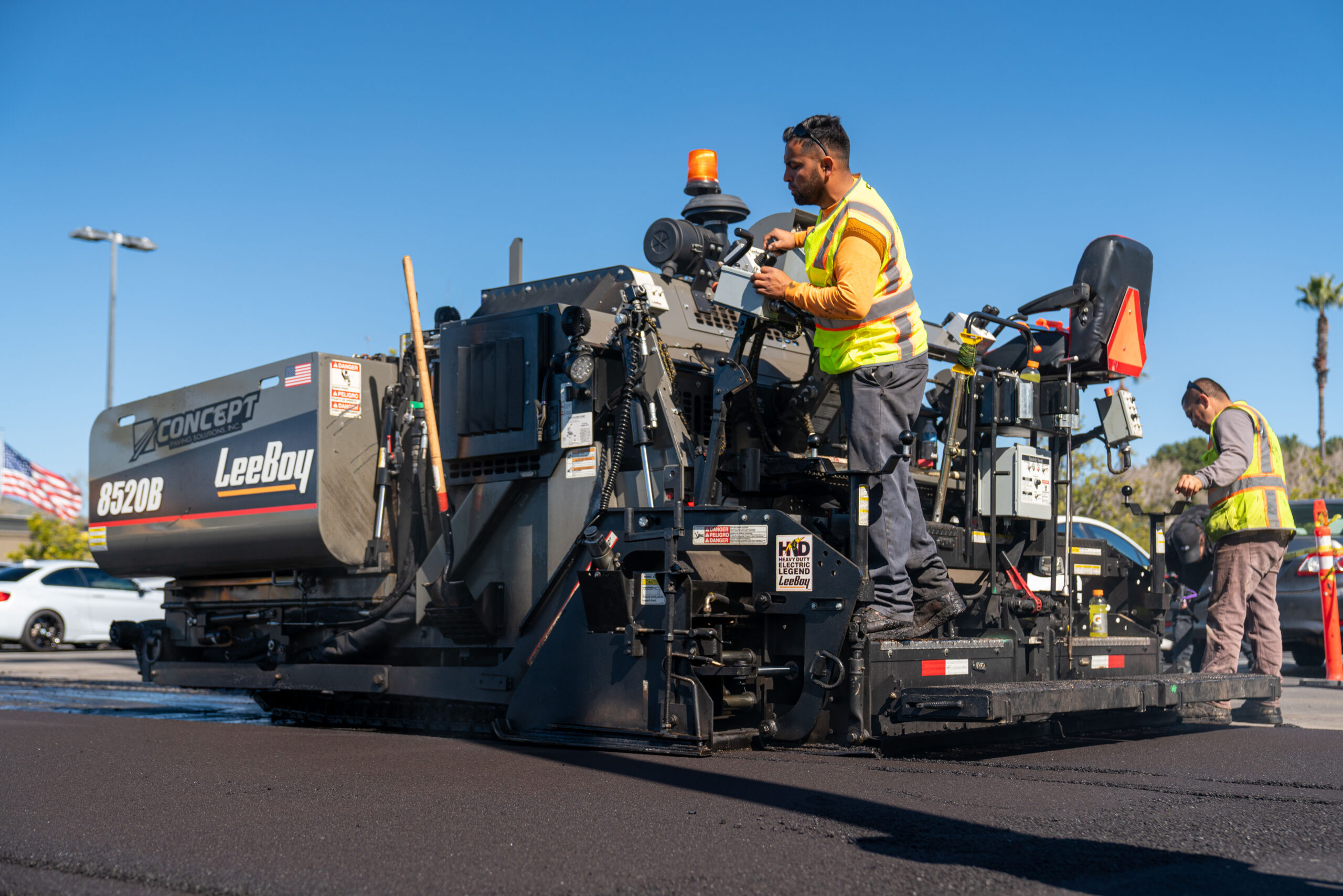 Asphalt paving machine laying fresh asphalt